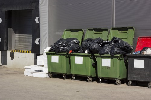 Vehicle and crew carrying out rubbish removal service
